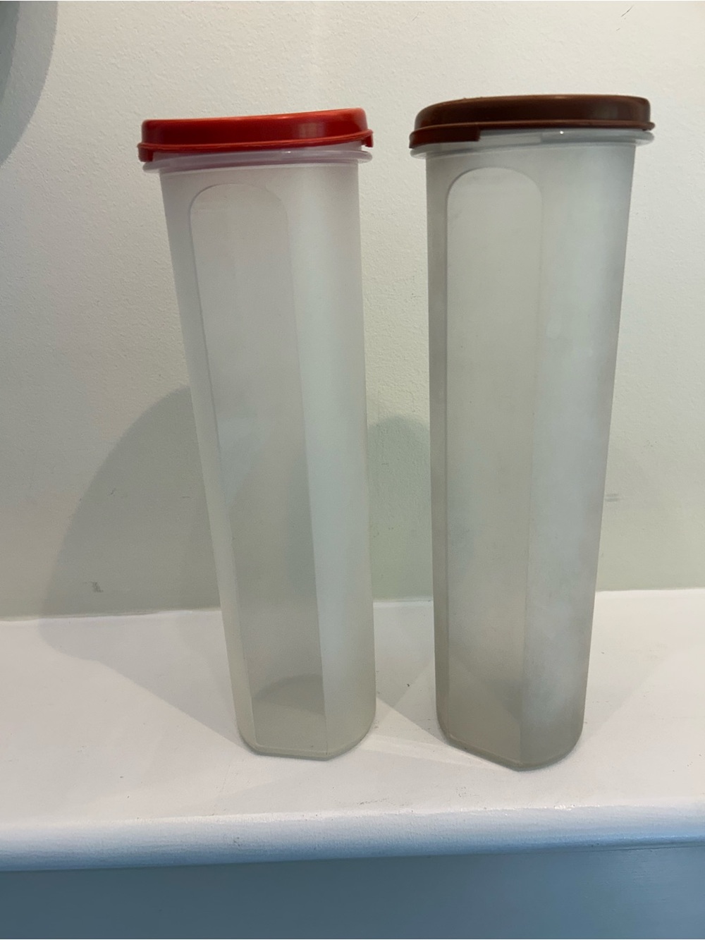 Two vintage Tupperware Spaghetti Round Dispensers red lid brown lid